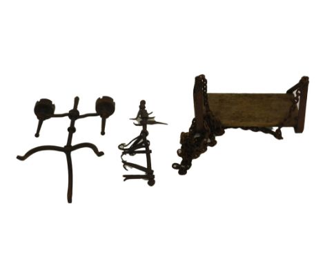 Architectural wares, comprising a gothic wrought iron candelabra, meat hanging rack and swing seat. (3)