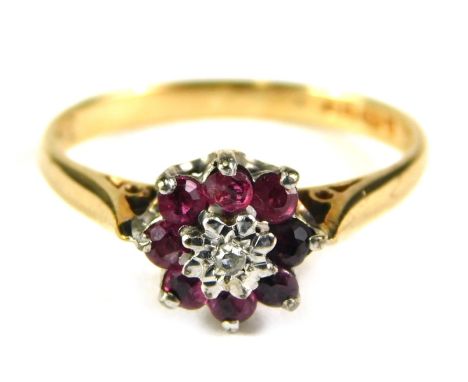 A 9ct gold floral cluster ring, set with garnet and tiny diamond centre, in raised basket setting, ring size l½, 2g all in. 