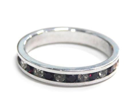 An eternity ring, tension set with red and white paste stones, in a silver coloured band, unmarked, ring size J½.
