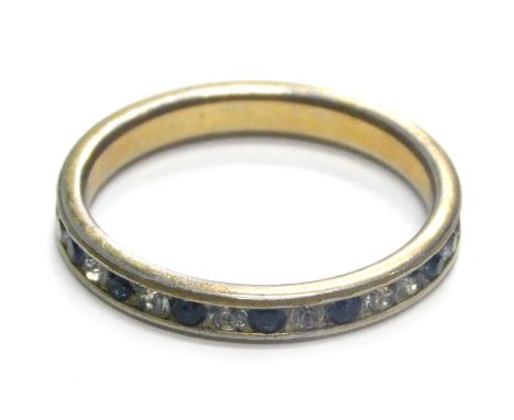 A 9ct gold and silver eternity ring, set with blue and white paste stones, some missing, ring size P½, 1.8g all in.