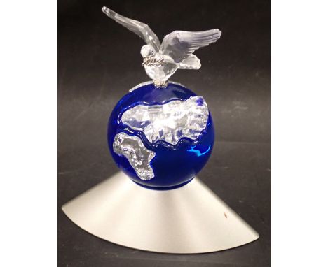 A Swaroski crystal Dove of Peace figure, depicting a dove on blue globe with chrome base, 12cm high. 