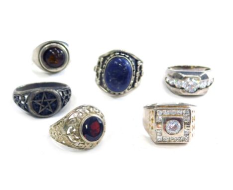 A group of silver dress rings, each stone set, two with cz stones, one set with lapis in the Eastern style, another set with 