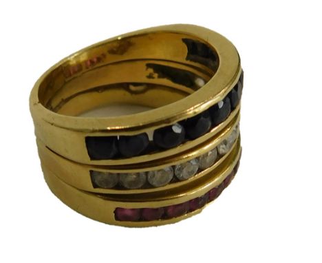 A dress ring, set with tension set rubies, sapphires and diamonds, on three band design, yellow metal unmarked, believed to b