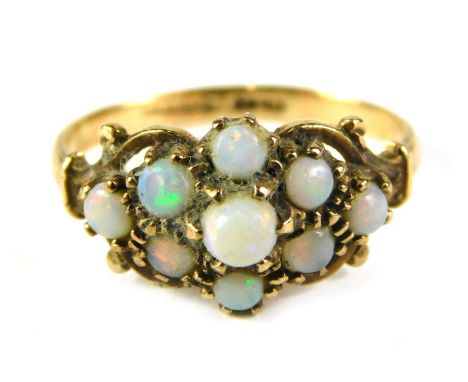 A 9ct gold opal dress ring, the flower design with scroll outer border, ring size L, 2g all in. 