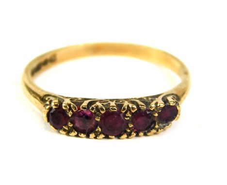 A 9ct gold dress ring, set with five garnets, on plain band, ring size P½, 2.1g all in. 
