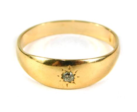 A diamond solitaire ring, the tiny diamond illusion set, on a yellow metal band, unmarked with reverse inscription 6-5, ring 