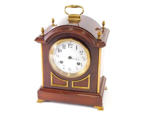 A late 19thC mahogany bracket clock, the 11cm diameter enamel dial surmounted with pineapple finials, with Arabic numerals, o