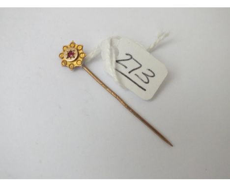 A garnet stick pin in 9ct 