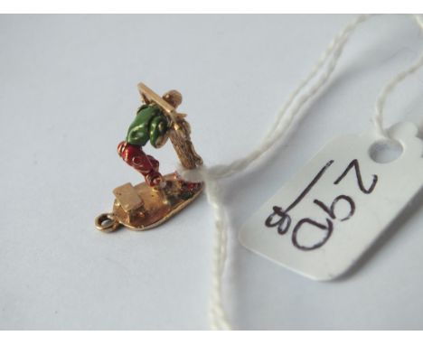 An unusual gold &amp; enamel charm in the form of a person in the stocks in 9ct -2gms