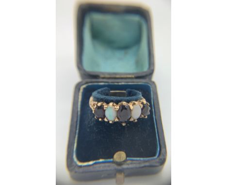 An opal and garnet ring, set in 9ct gold in vintage ring box. Size R. Weight 4gm.Condition ReportGood condition.