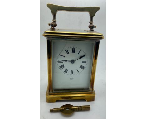 A French brass cased carriage clock with white enamel face and Roman dial stamp 'Byrne Paris'. Key included. Winds and goes. 