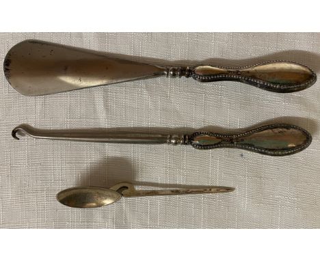 Three pieces of silver to include silver handled shoe horn and button hook Birmingham 1908 and spoon Birmingham 1986.Conditio
