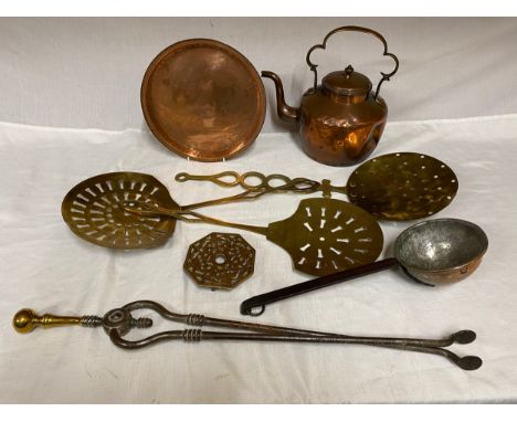 Selection of copper and brass to include copper kettle and tray, brass trivet, tongs, 3 x chestnut roasters and a ladle.Condi