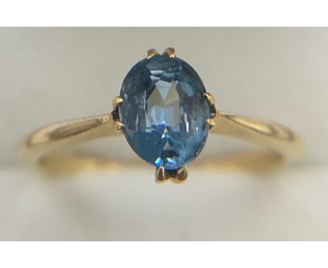 An 18 carat gold ring set with blue gem stone. Size M. 2gm.Condition ReportGood condition.