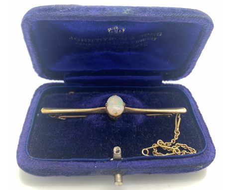 Nine carat gold bar brooch set with Opal with safety chain, 6cm l. Total weight 4gm.Condition ReportGood condition.