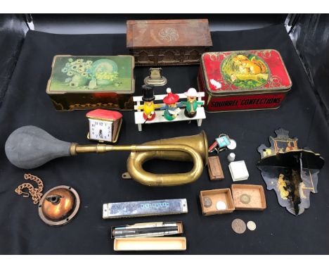 A mixed lot to include 2 tins, music box, novelty bottle and corkscrew set, travel clock, old car horn 45 cm, ornamental blac