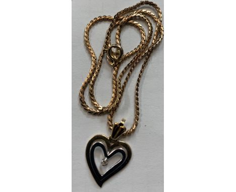 A 9 carat yellow and white gold heart set chain with diamond. 36cm l. 5.7gm.