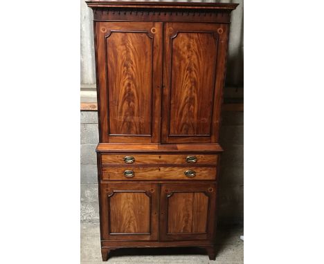 A Regency mahogany tall cabinet on chest, two door base with fitted drawers interior shelved top. 240cms h x 113cms w.Conditi