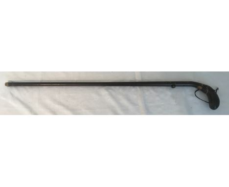 A .410 walking stick shotgun, steel with colouring to resemble wood, curved wood handle, barrel length 73cms, overall length 