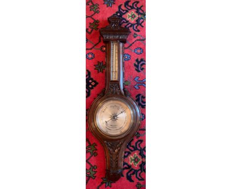 A well carved oak aneroid barometer. James Lucking &amp; Co, Birmingham. 99cm h.Condition ReportSlight chip at top, otherwise