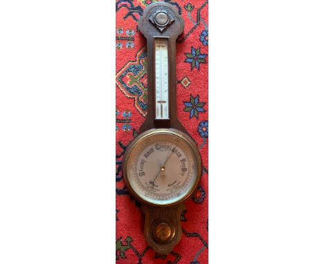 An oak aneroid barometer 78cm h.