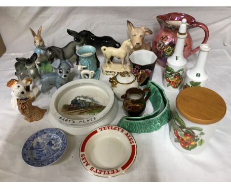 A selection of ceramics to includes Beswick donkey, Peter Rabbit and long haired dog, a Wade dog, Sylvac dog and vase with la