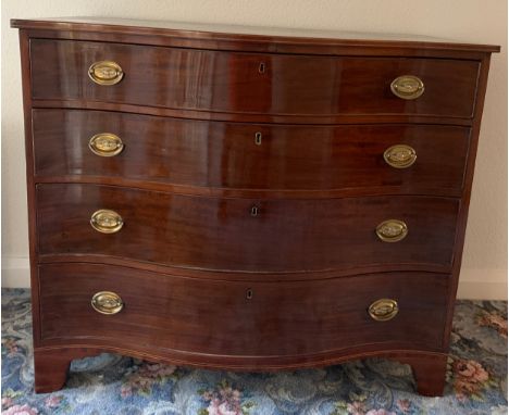 A mahogany and string inlaid serpentine fronted chest of 4 drawers on bracket feet and brass drop handles. 114 w x 58 d x 98 