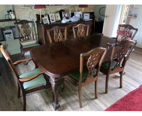 A mahogany wind out dining table on cabriole legs with ball and claw feet together with 8 chairs including 2 carvers in Chipp