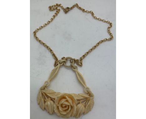A 9 carat gold chain with carved ivory rose pendant. 14.3gm total weight.Condition ReportCrack to back of pendant.