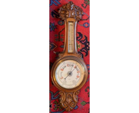 A finely carved light oak aneroid barometer. E. F. Lundy, Grimsby. 87cm h.Condition ReportGood condition.