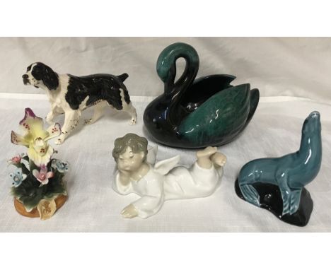 A mixed lot of ceramics  to include: Lladro angel 7cm h, Poole seal 11cm h, Capodimonte flower 12cm h, Beswick spaniel dog 12