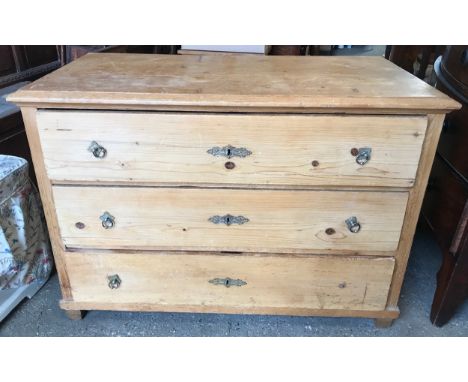 A pine chest of 3 long drawers, 114 w x 59 d  x 80cms h.Condition ReportRing and water marks to top. Some scratching. Missing