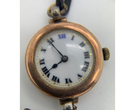 A ladies 9ct gold wristwatch 2.5cm d with white enamel face and leather strap. Total weight 17.1gm.Condition ReportNot workin