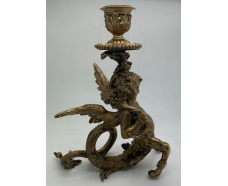 A good quality brass winged cherub candlestick. 17.5cm.Condition ReportGood condition.