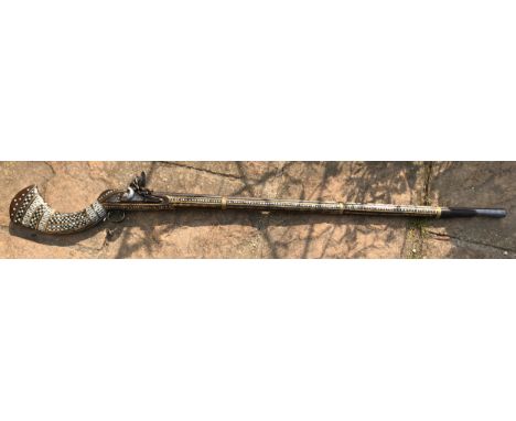 Northwest Frontier Flintlock Musket with a 45'' tapered and ribbed barrel, stock heavily decorated with inlaid brass and moth