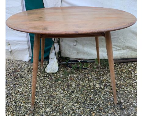 An Ercol oval topped dining table with under rack shelf and blue label. Top 99 x 89 x 73cm hCondition ReportSigns of use, sur