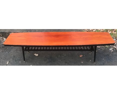 Mid century teak topped long coffee table, black painted base and shelf under. 179 l x 40 d x 50cm h.Condition ReportDents an