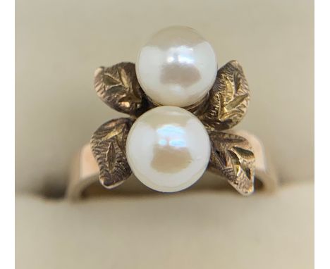 Ring marked 14K, leaf design set with two pearls, size L, weight 4.3gm.Condition ReportGood condition.