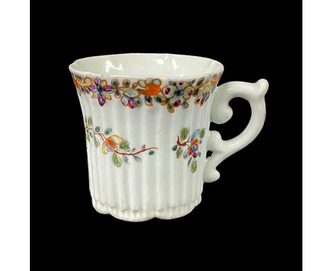 EARLY WORCESTER PORCELAIN COFFEE CUP, c. 1753, finely reeded form with a flared lobed rim, scroll handle with a spur thumbres