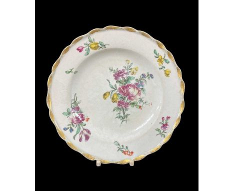 BOW PORCELAIN TEA PLATE, c. 1765, with gilt scalloped rim, decorated with sprays and sprigs of summer flowers, base with iron