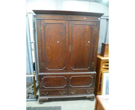 George III oak two section livery cupboard, the moulded dentil cornice over a pair of beaded doors, the base with rectangular