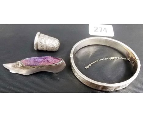 A Charles Horner silver thimble; together with an Edwardian silver slipper pin cushion and a silver bangle (3).
