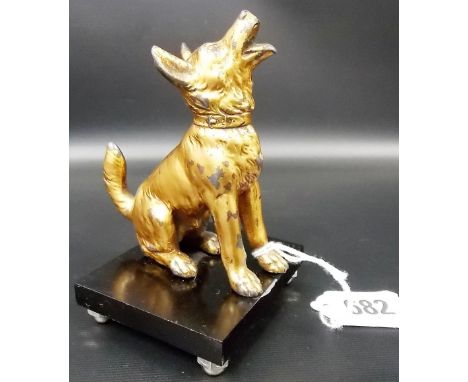 A gilt painted spelter model of a seated Alsatian upon black celluloid square plinth, height 4.25'