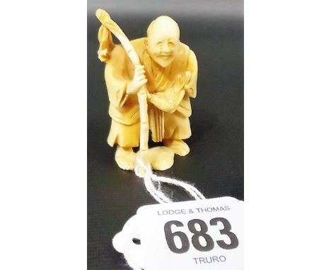 Japanese ivory netsuke carved as an elderly fisherman, height 2'