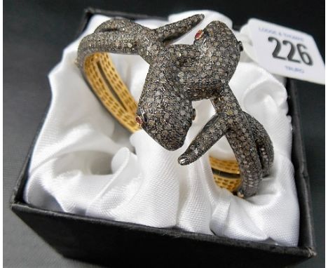 Good contemporary silver and gilt diamond and ruby double snake bangle, weight 47.5gms approx.
