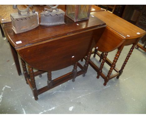 Oak oval gateleg table by Maples, with bobbin turned supports; together with a smaller oak barley twist gateleg table (2)