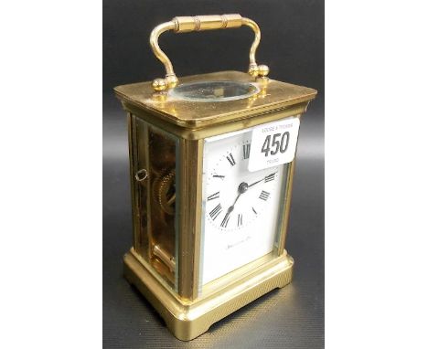 A carriage clock by Duverdray & Bloquel, the white enamel dial with Roman numerals and retailers Harrods Ltd, height includin