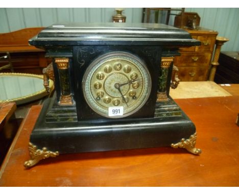 Black painted slate and marbel simulated three train mantle clock with 5' brass circular dial and gilt painted metal mounts, 