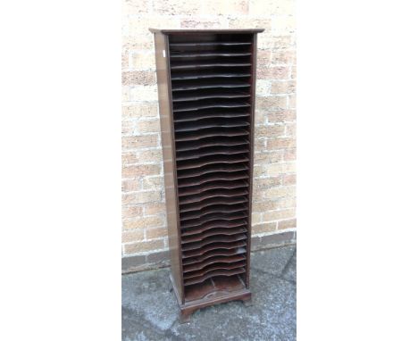 AN EDWARDIAN MAHOGANY STATIONERY/MUSIC CABINET  with twenty-eight compartments on short splayed bracket feet, 38cm wide 130cm