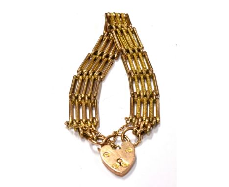 AN EARLY 20TH CENTURY GOLD PART-TEXTURED FIVE BAR GATE BRACELET on a padlock clasp, stamped '9', 18g 